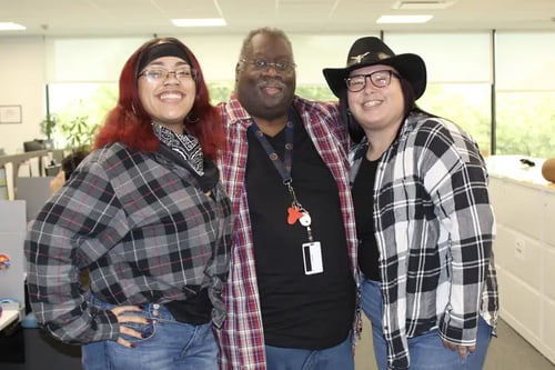 Three smiling NetTEL employees